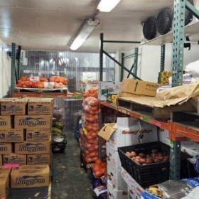 Shelves of produce inside refrigeration space