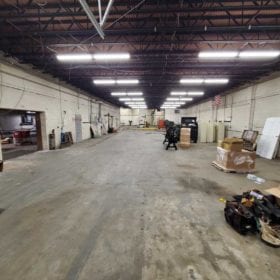Alternate view of working area showing concrete floors and heavy machinery