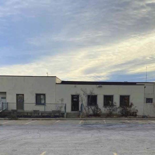 Exterior of single story warehouse with docks and drive-in loading